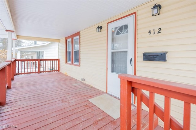 wooden terrace featuring covered porch