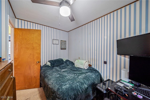 carpeted bedroom with wallpapered walls and a ceiling fan