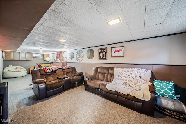 living room with a wainscoted wall and carpet flooring