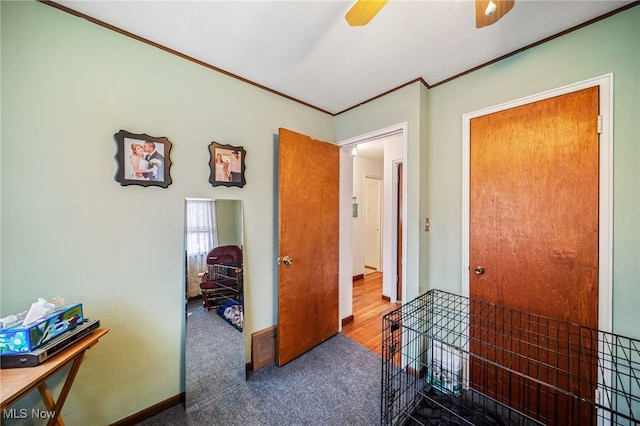 hallway with carpet, baseboards, and crown molding