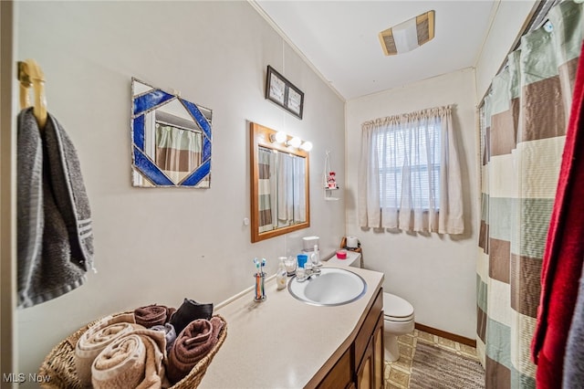 bathroom with baseboards, vanity, toilet, and a shower with curtain