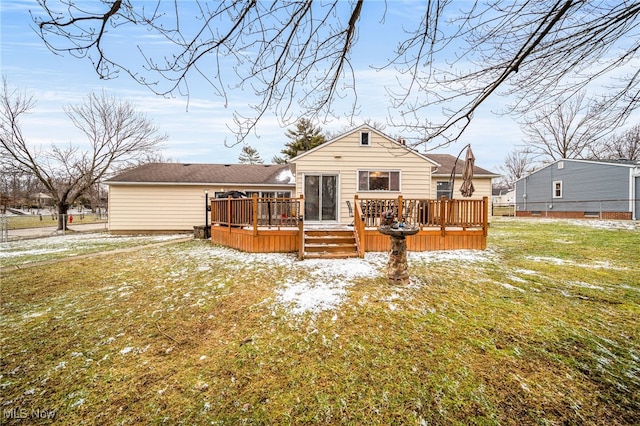 back of property with a yard and a wooden deck