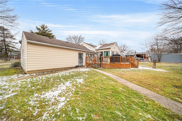 back of house with a yard, a wooden deck, and fence