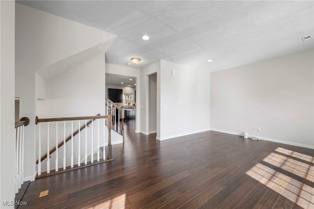 spare room with stairs, recessed lighting, wood finished floors, and baseboards