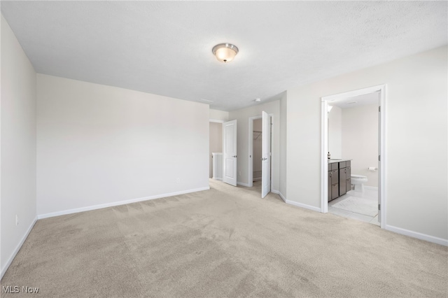 spare room with light colored carpet and baseboards