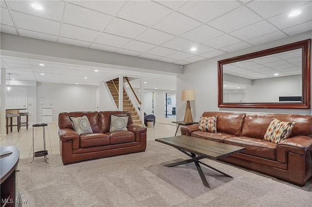 carpeted living room featuring tile patterned flooring, stairs, a drop ceiling, and recessed lighting