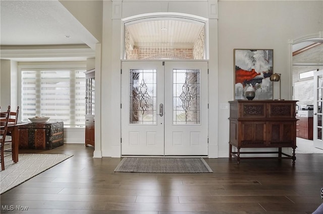 foyer entrance featuring wood finished floors and french doors