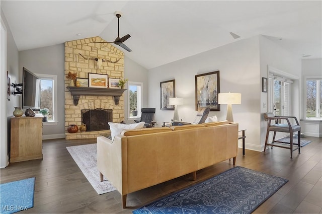 living room with dark wood-type flooring, a fireplace, and a healthy amount of sunlight