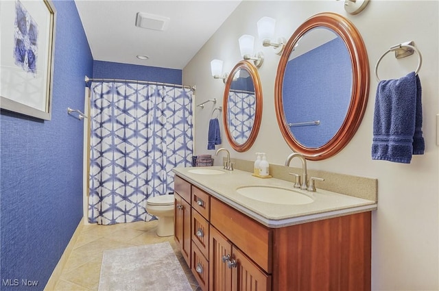 full bathroom with double vanity, a sink, toilet, and tile patterned floors