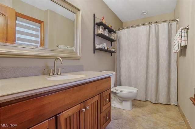 bathroom with a shower with shower curtain, tile patterned flooring, vanity, and toilet