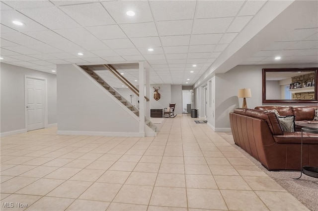 living room featuring recessed lighting, stairs, baseboards, and light tile patterned flooring