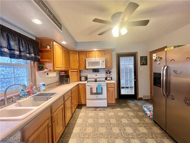 kitchen featuring open shelves, light countertops, visible vents, a sink, and white appliances
