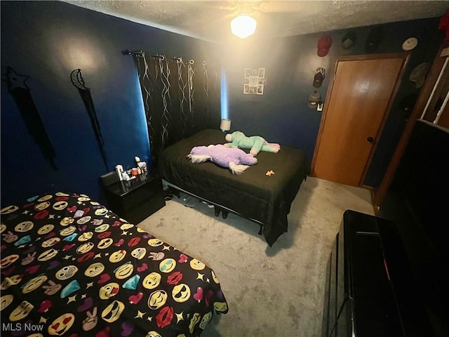 carpeted bedroom featuring a textured ceiling