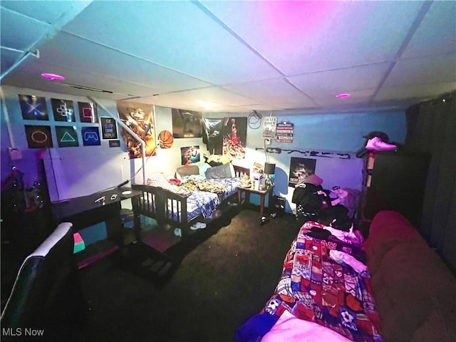 rec room with a paneled ceiling and carpet