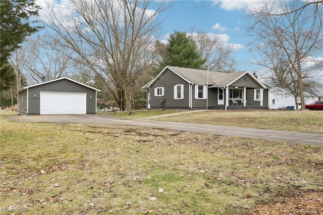 ranch-style house with a garage, an outbuilding, and a front lawn