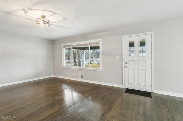 entryway featuring visible vents, baseboards, and wood finished floors