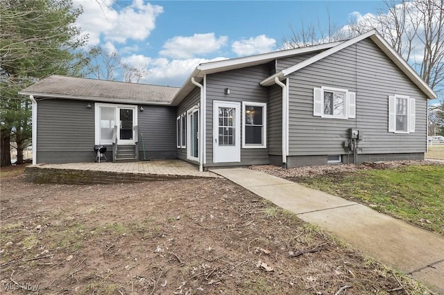 rear view of property with entry steps and a patio area