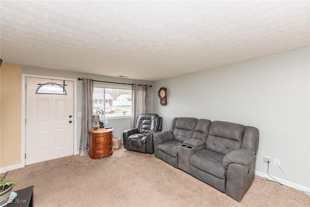 carpeted living room with a textured ceiling and baseboards