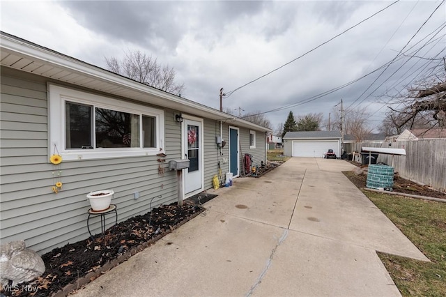 view of property exterior with a garage, fence, and an outdoor structure