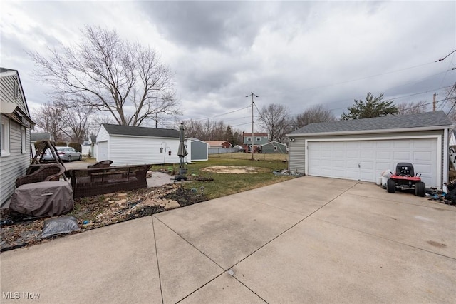 view of yard with an outbuilding and a detached garage