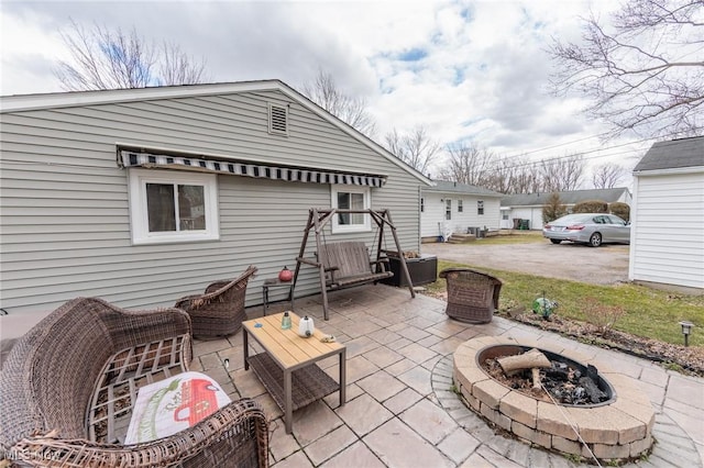 view of patio / terrace featuring an outdoor fire pit