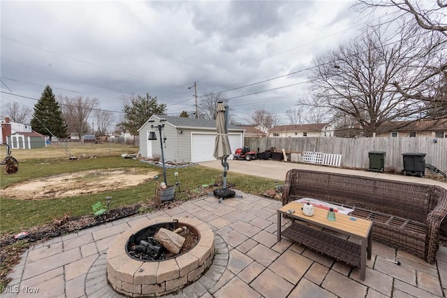 view of patio featuring a fire pit, an outdoor structure, and fence