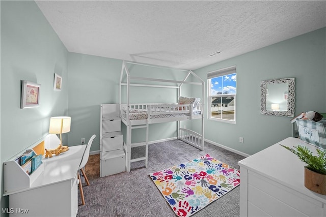 carpeted bedroom featuring visible vents, a textured ceiling, and baseboards