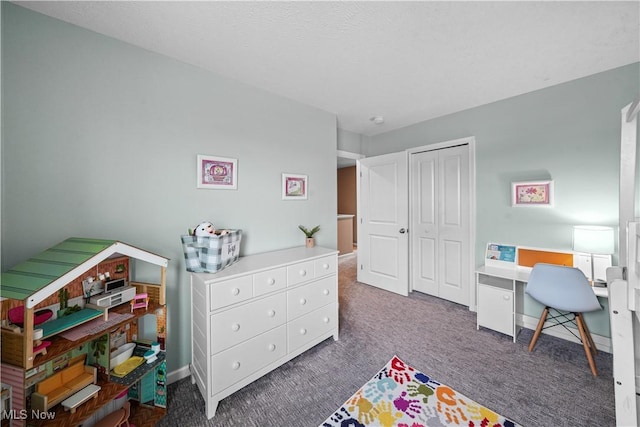 carpeted bedroom featuring a closet and baseboards