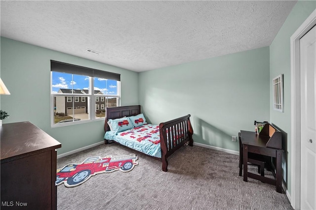 carpeted bedroom featuring visible vents, a textured ceiling, and baseboards