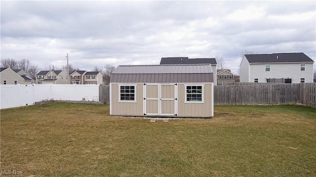 view of shed featuring a residential view and a fenced backyard