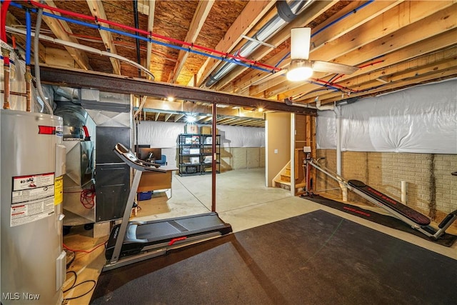 unfinished basement with stairway and electric water heater