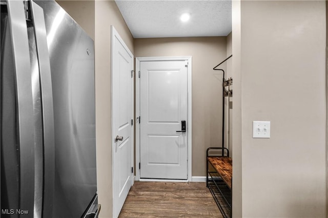 entryway featuring a textured ceiling and wood finished floors