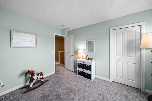 bedroom featuring a closet, baseboards, and carpet floors