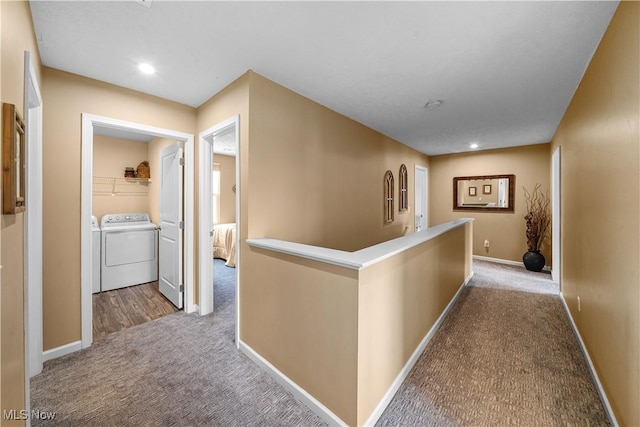 hallway with an upstairs landing, recessed lighting, carpet floors, baseboards, and washing machine and clothes dryer