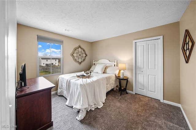 bedroom with a textured ceiling, baseboards, and carpet floors