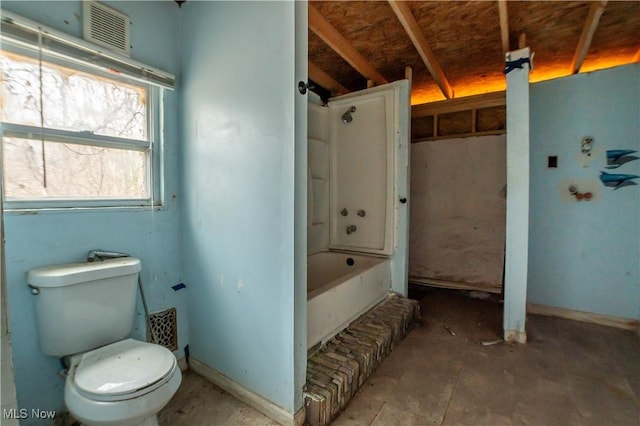 bathroom with shower / washtub combination, baseboards, and toilet