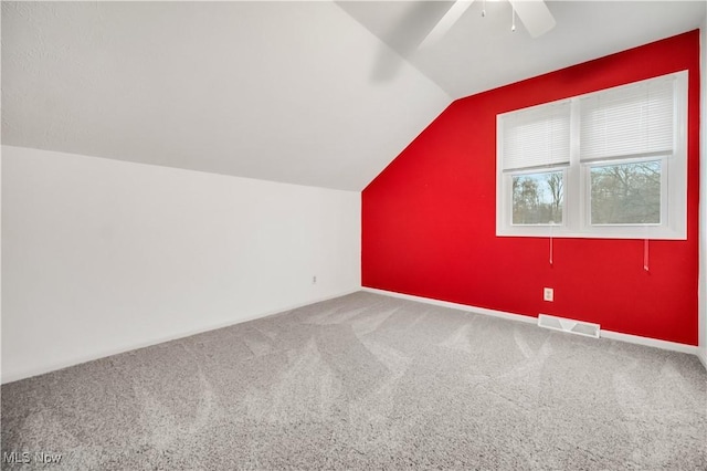 bonus room featuring ceiling fan, carpet, visible vents, and vaulted ceiling