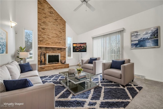 living area featuring carpet floors, visible vents, a brick fireplace, ceiling fan, and high vaulted ceiling