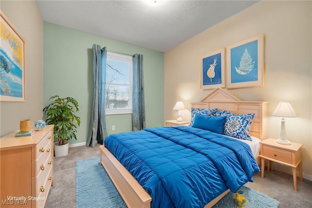 bedroom with light carpet and baseboards