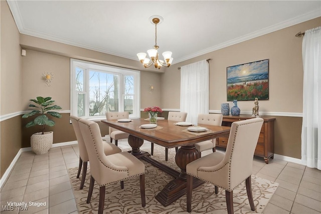 dining room featuring crown molding, an inviting chandelier, and light tile patterned floors