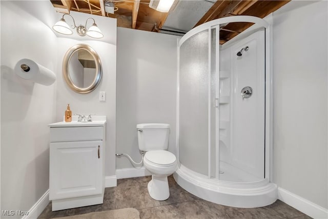 full bath with toilet, a stall shower, vanity, and baseboards