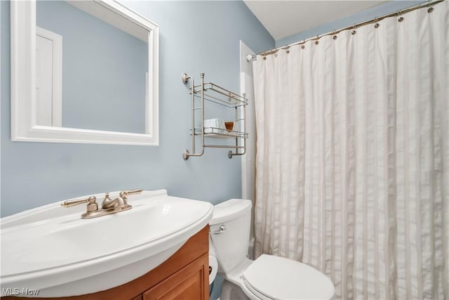 bathroom featuring toilet, a shower with curtain, and vanity