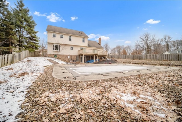 rear view of house with a patio area, a fenced backyard, a chimney, and a wooden deck