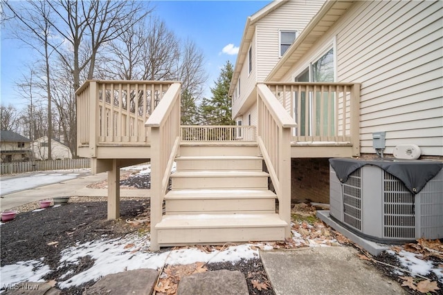 wooden terrace featuring central AC unit and stairway