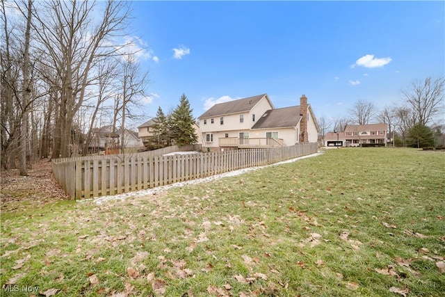 view of yard featuring fence and a wooden deck