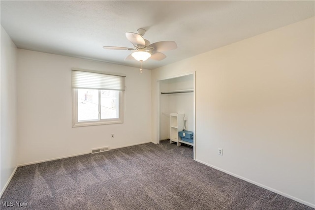 unfurnished bedroom with carpet floors, a closet, visible vents, a ceiling fan, and baseboards