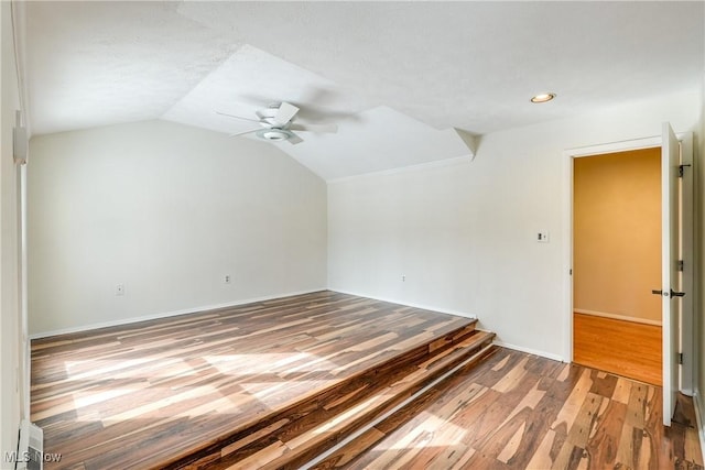 empty room with recessed lighting, a ceiling fan, baseboards, vaulted ceiling, and light wood-type flooring