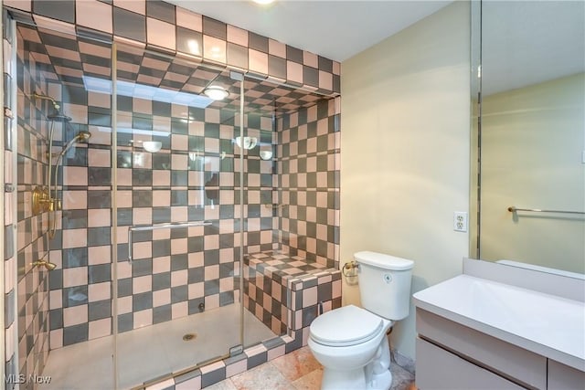 bathroom featuring a shower stall, toilet, and vanity