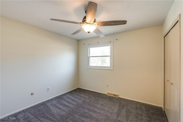 unfurnished bedroom with carpet floors, a closet, visible vents, and baseboards