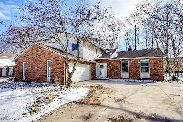 traditional-style home with driveway, a garage, a chimney, and brick siding